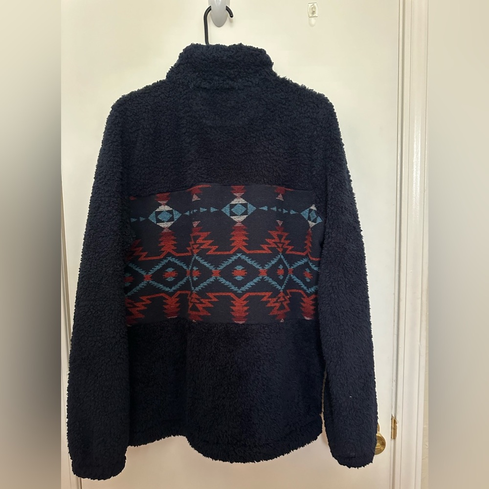 Outback Trading Company. navy with Aztec designer. Does not have pockets.